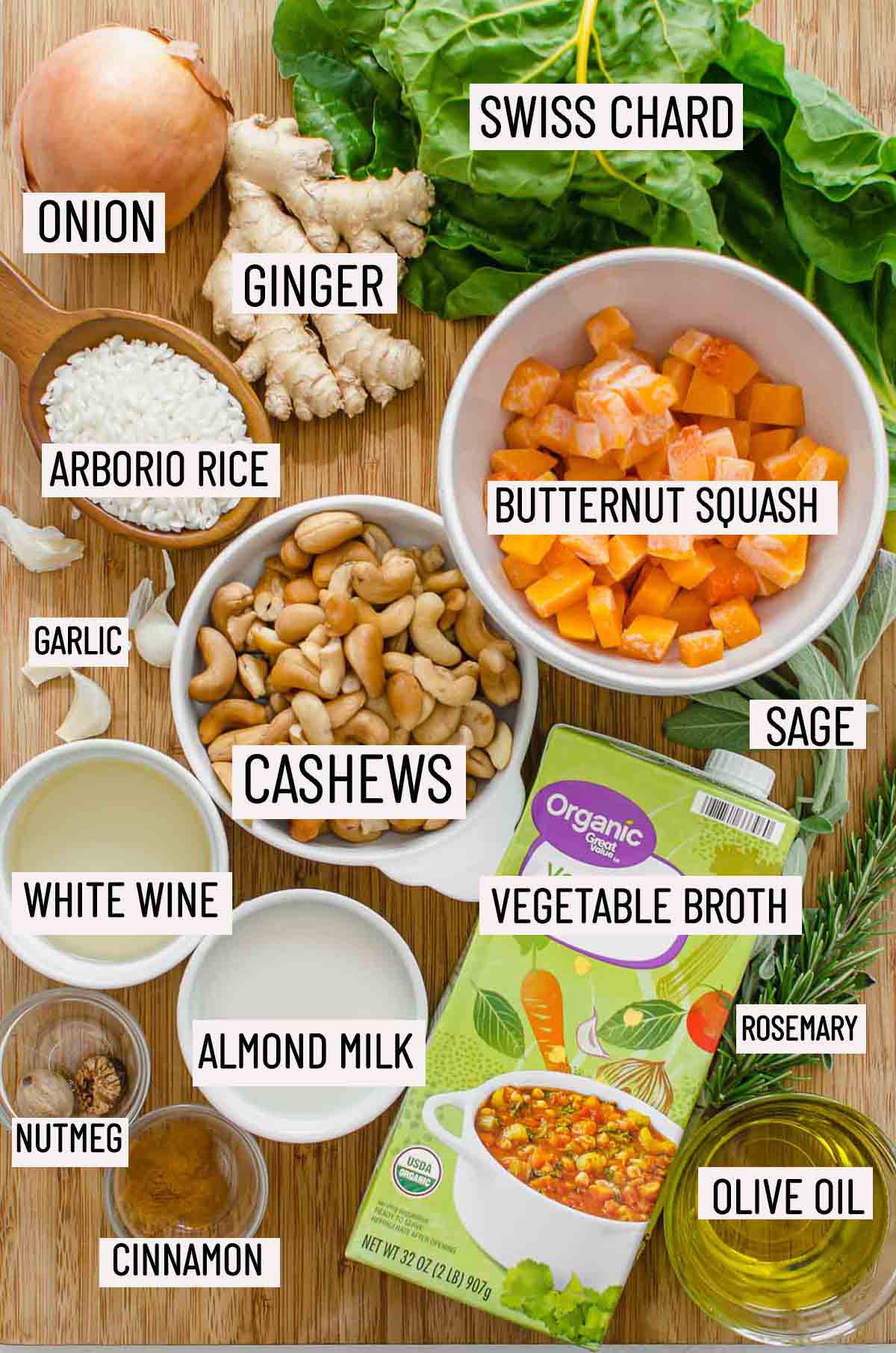 Portioned ingredients needs to make risotto including butternut squash, rice, wine, cashews, onion, garlic, swiss chard, sage, rosemary, broth, almond milk, olive oil, cinnamon, and nutmeg.