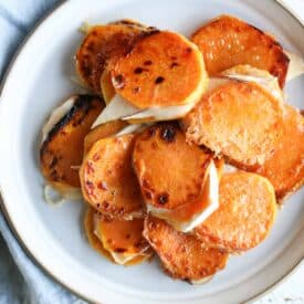 Overheat image of a plate with multiple sweet potatoes grilled cheese bites on a white plate.