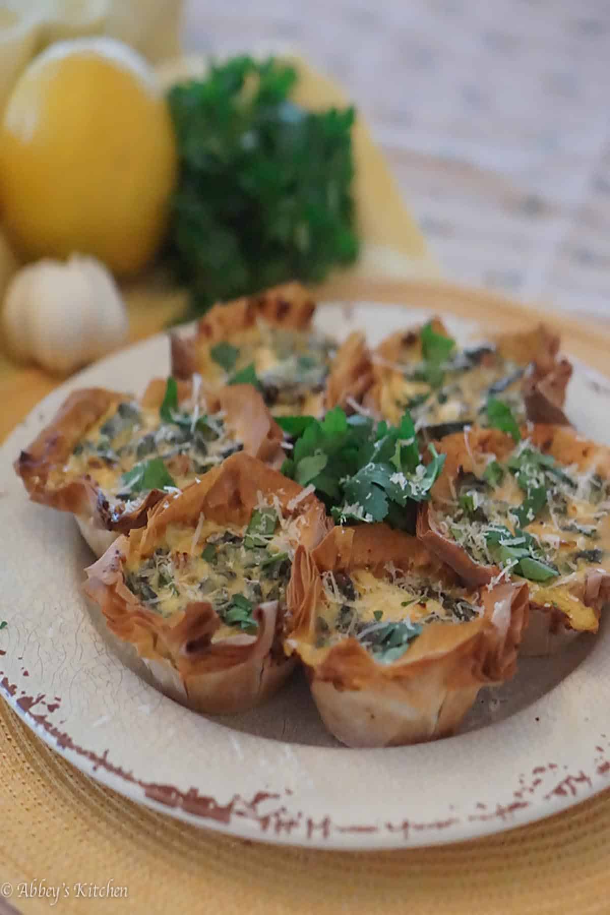 Several mini quiche's on a white plate. 