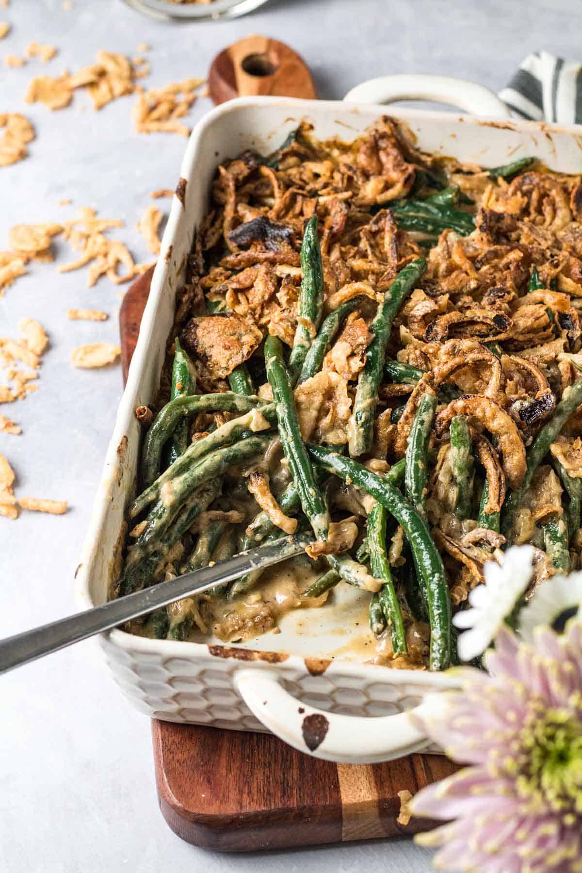 Close up of vegetable casserole in. a baking dish topped with crispy onions. 