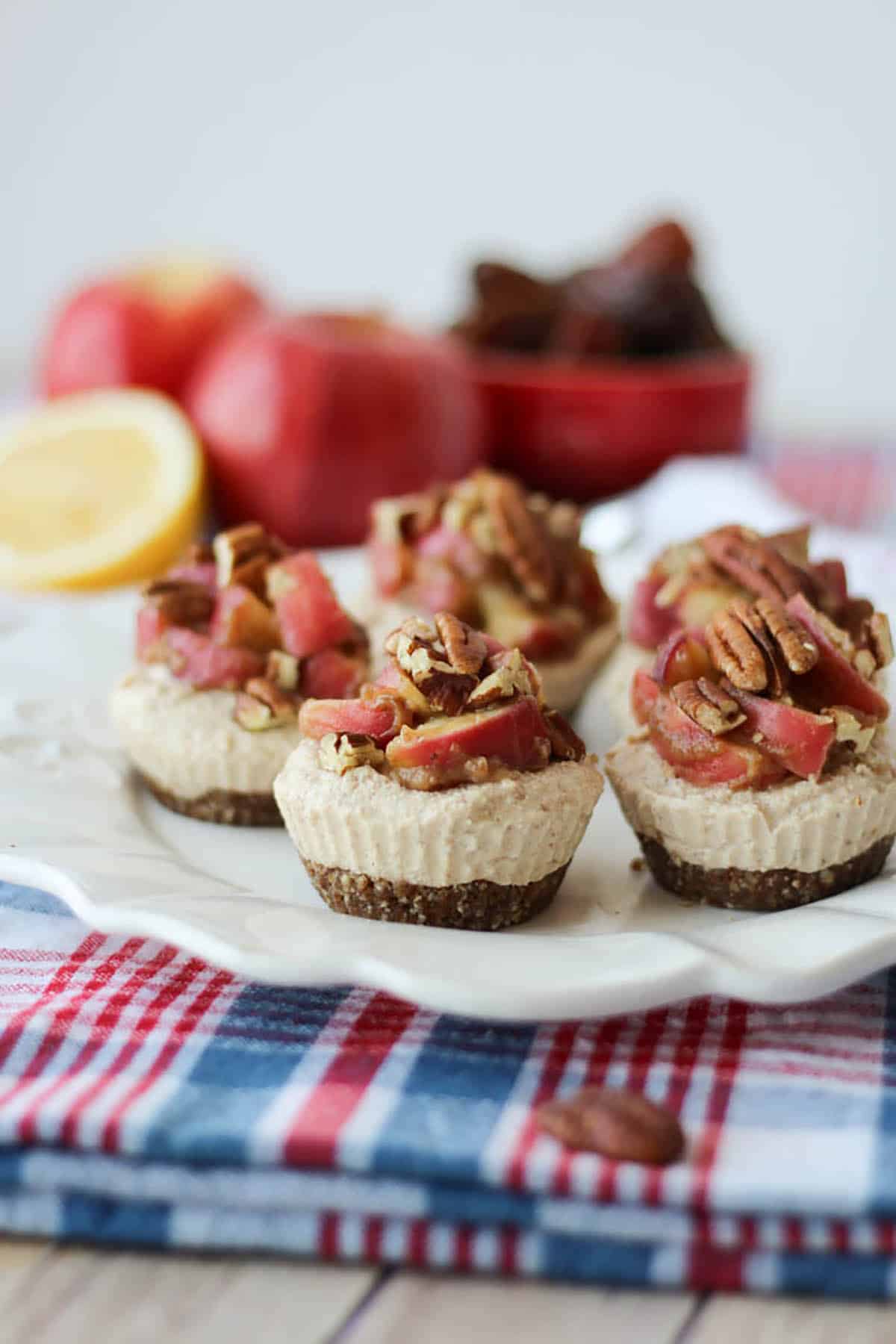 Several raw vegan cheesecakes on a plate. 