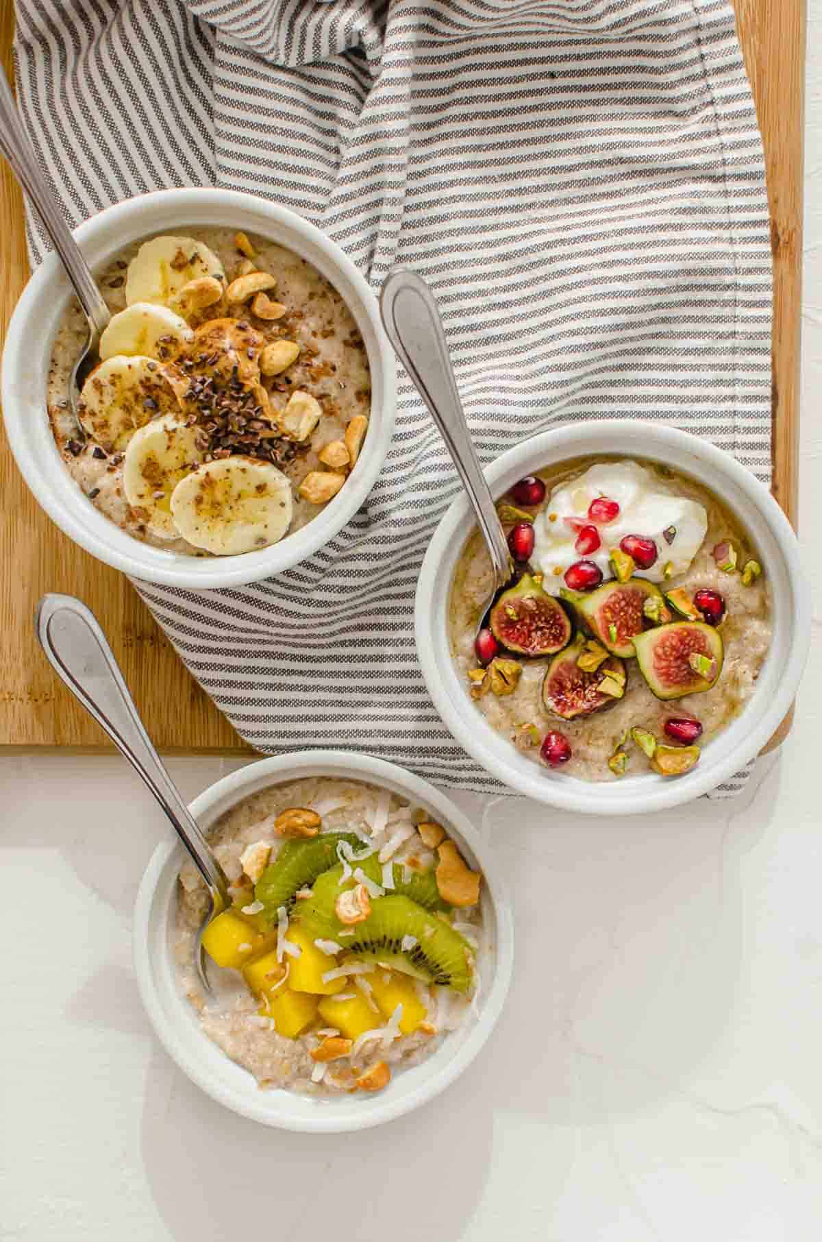 Birds eye view of three protein oatmeal bowls with different topping variations. 