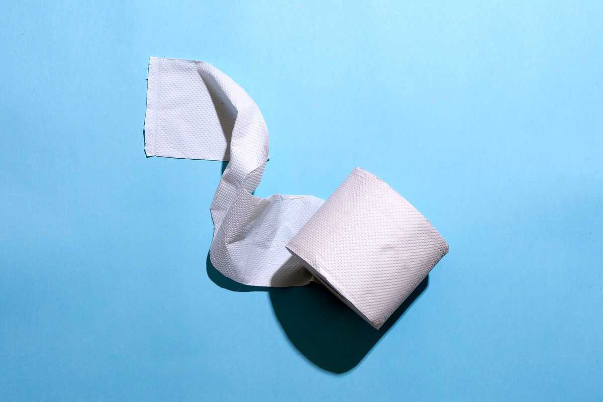 Image of a roll of toilet paper against a blue background.