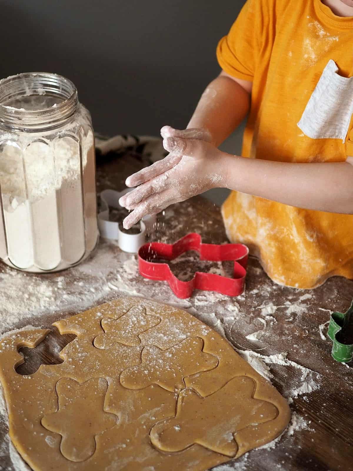 A small child making gingerbread cookies using the healthiest flour. 