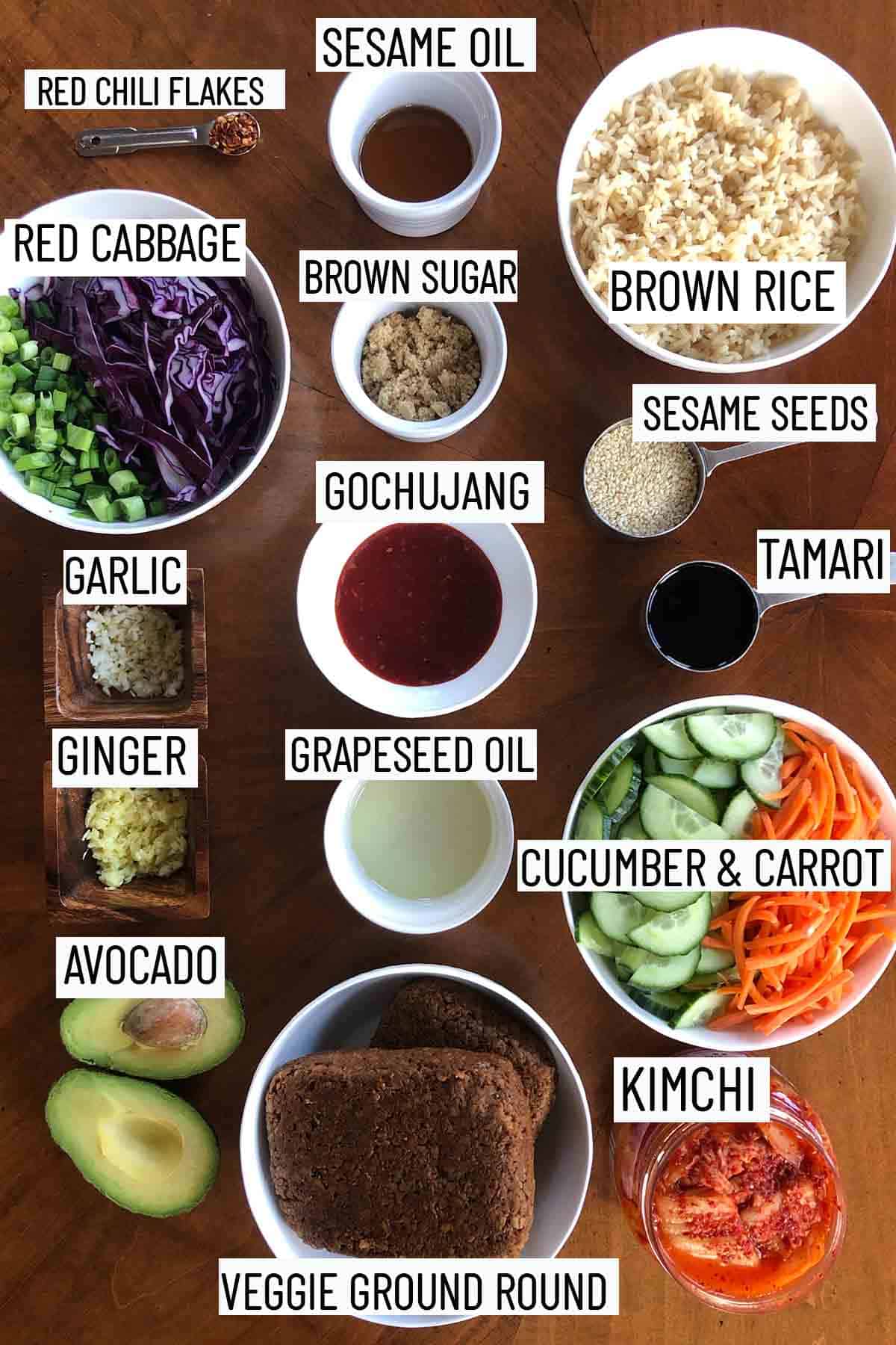 Flat lay image of portioned ingredients for recipe including the vegetable toppings, ingredients for the sauce, and the veggie meat. 