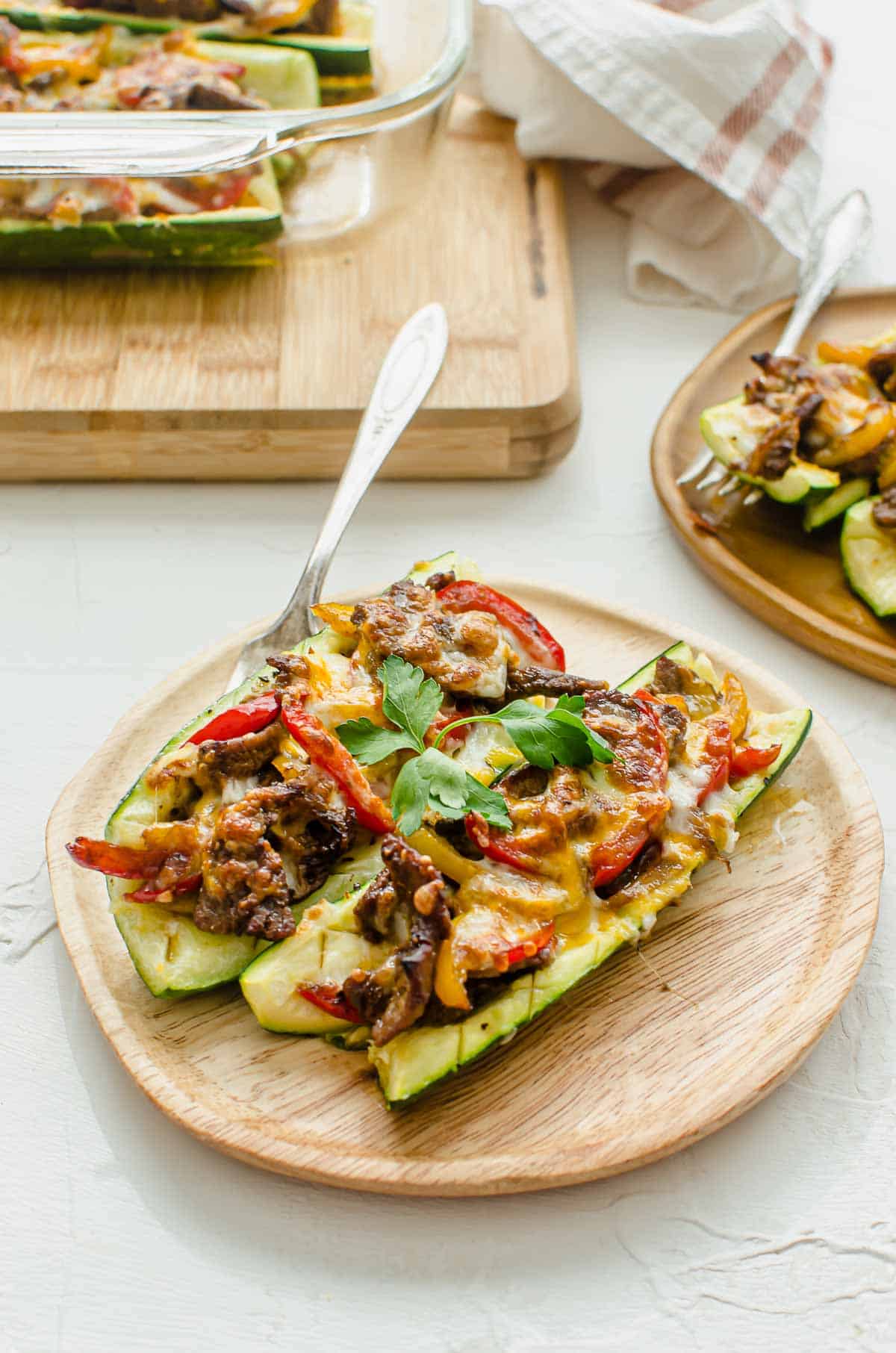 Close up of low carb cheesesteak on a wooden plate.