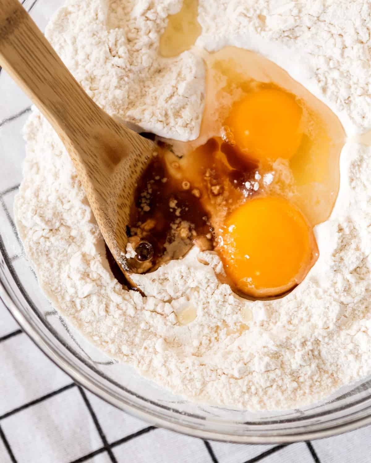Eggs being mixed with flour in a mixing bowl. 
