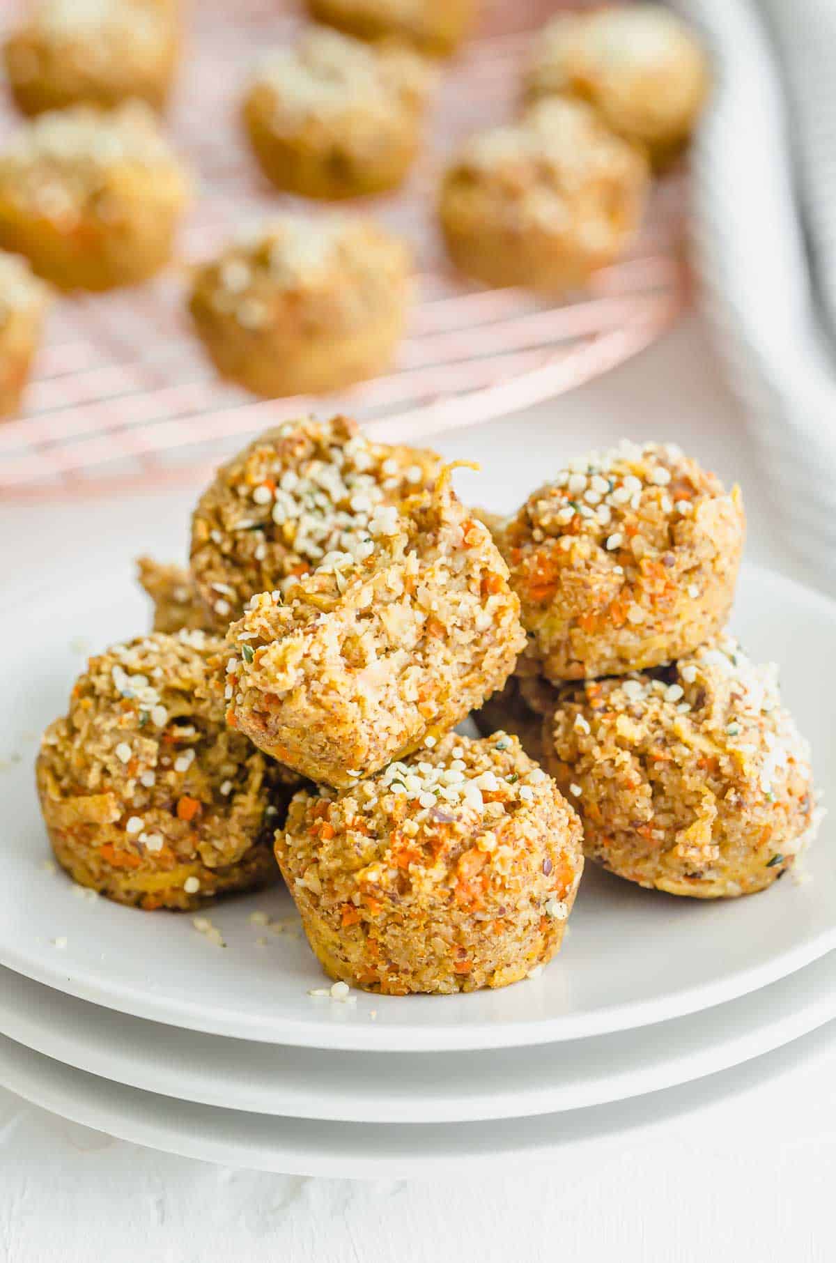 Close up of several baby muffins on a white plate.