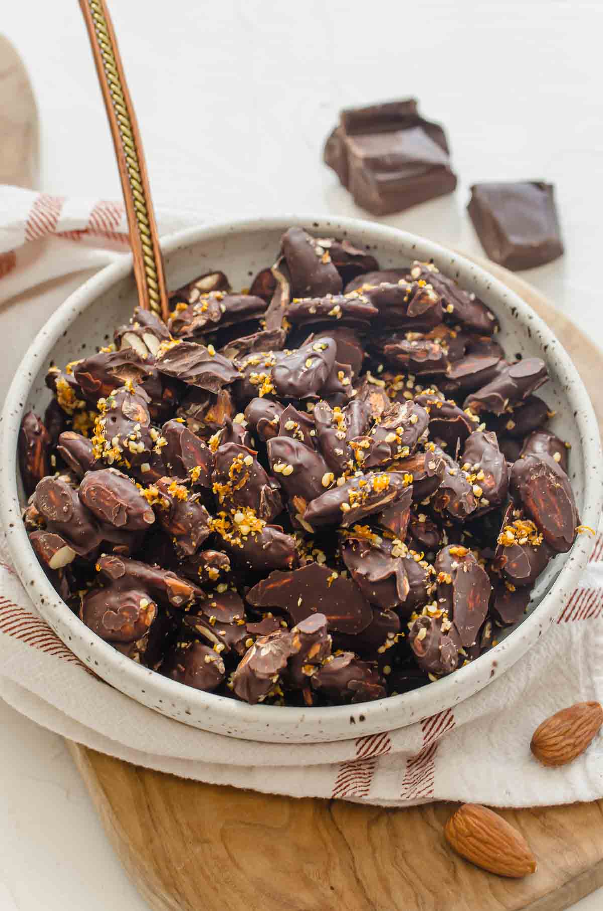 A bowl of chocolate covered nuts.