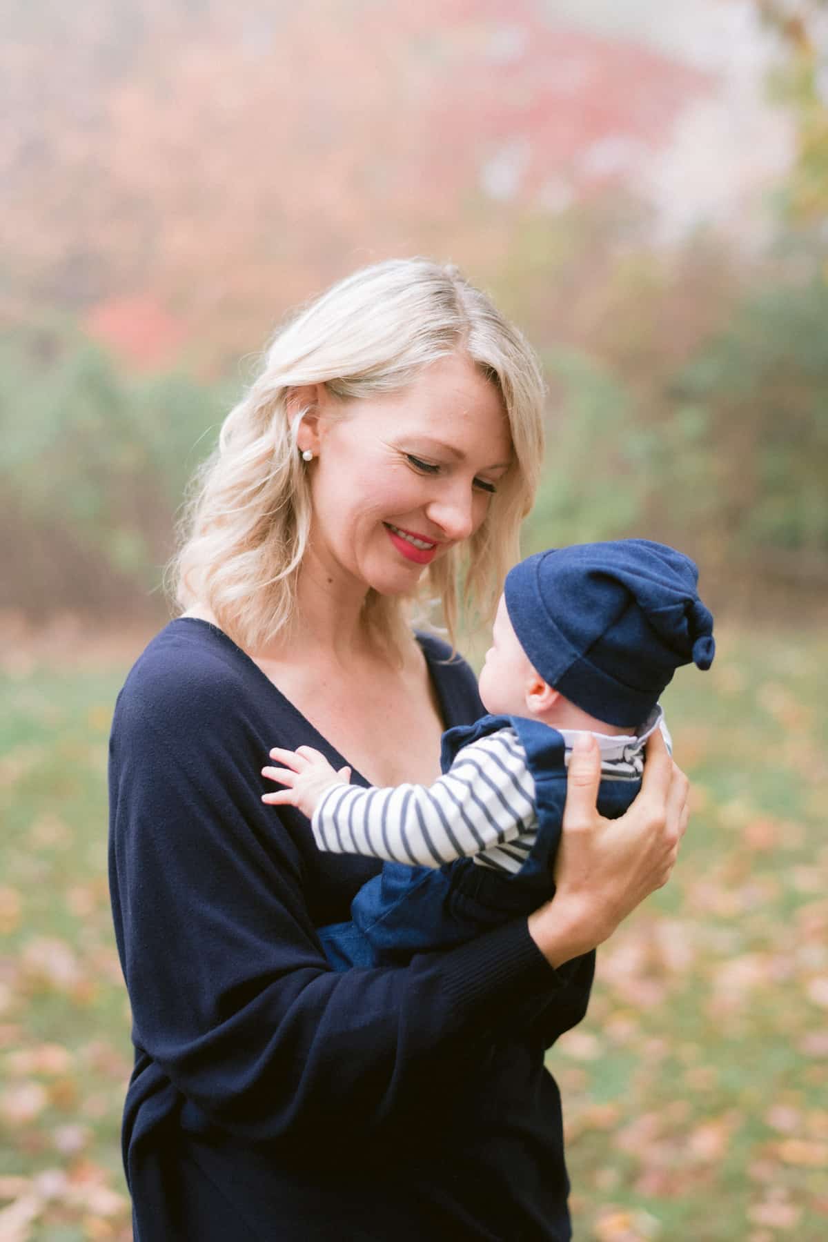 Abbey outside holding breastfed Baby O. 