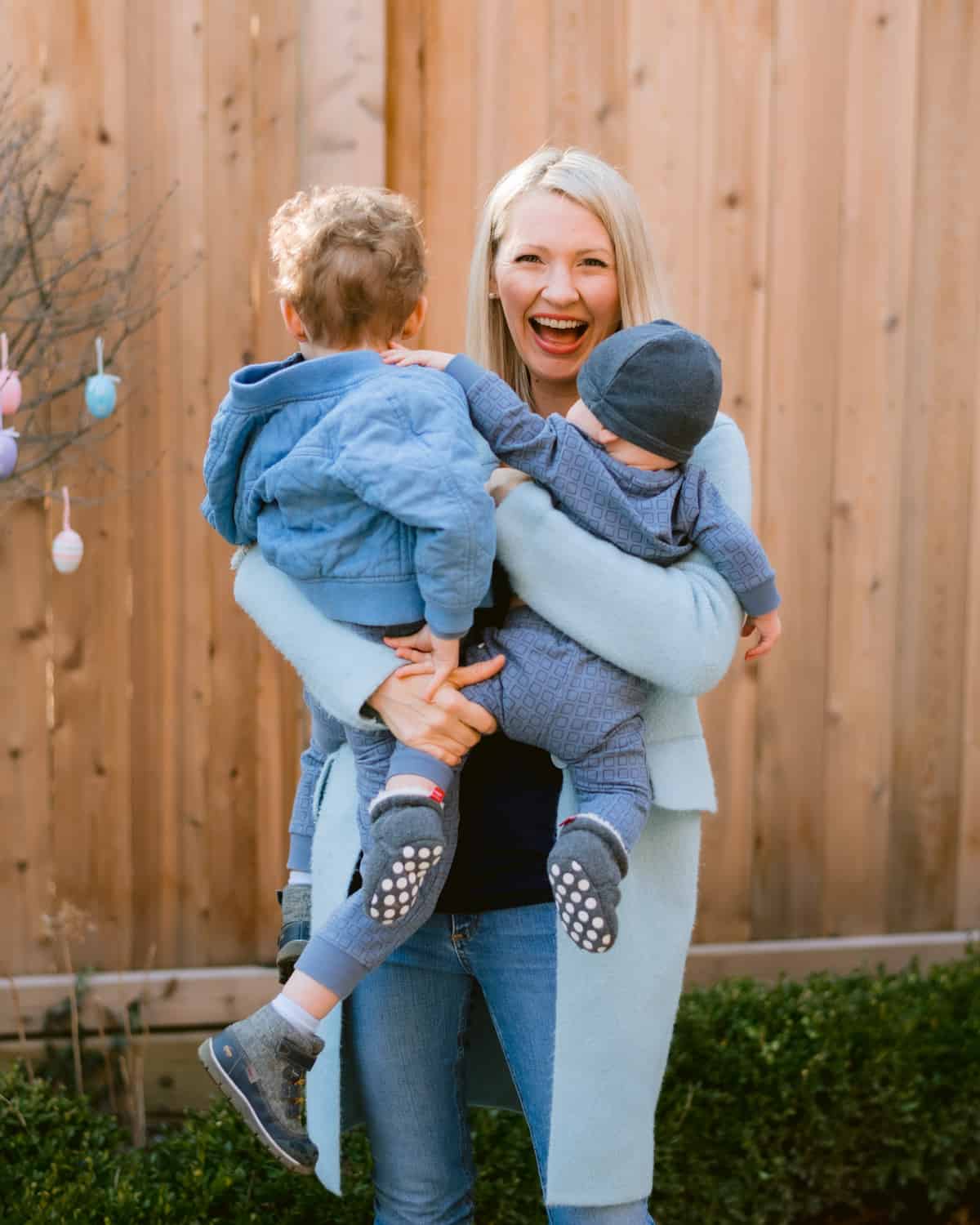 Abbey carrying Baby O and Big Boy E outside.