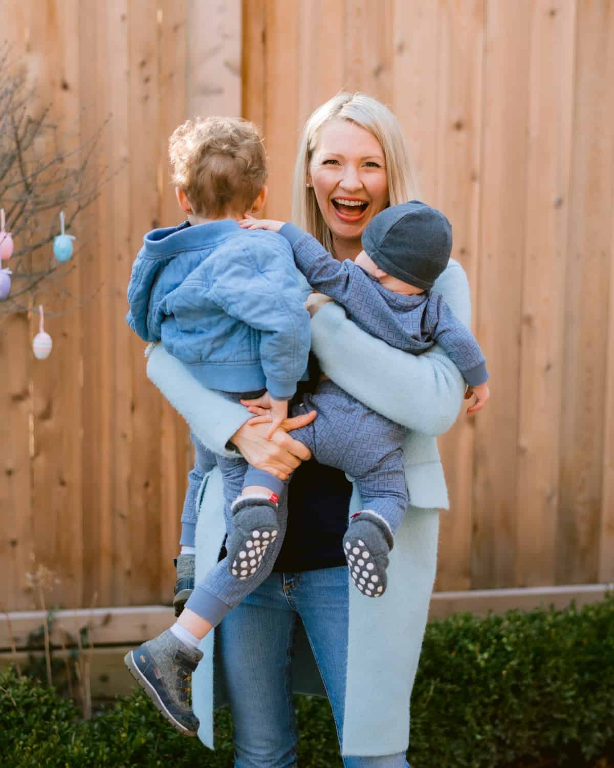 Abbey carrying Baby O and Big Boy E outside. 