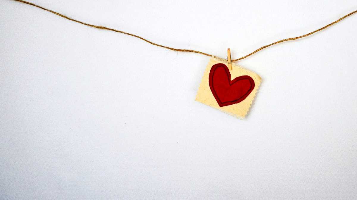 A picture of a heart hanging from a string. 