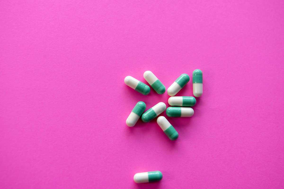 Pills against a pink background.