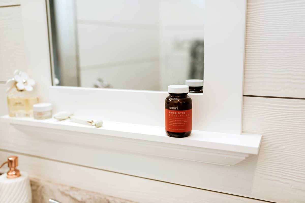 A pill bottle on a shelf. 