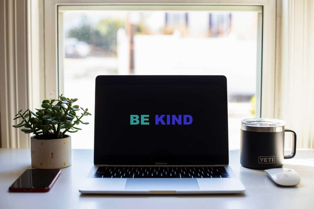 A computer screen background that says "be kind" while dealing with quarantine weight gain. 