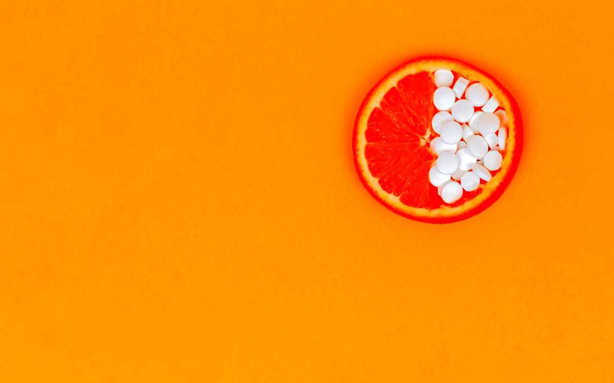 Collagen supplements on an orange slice.