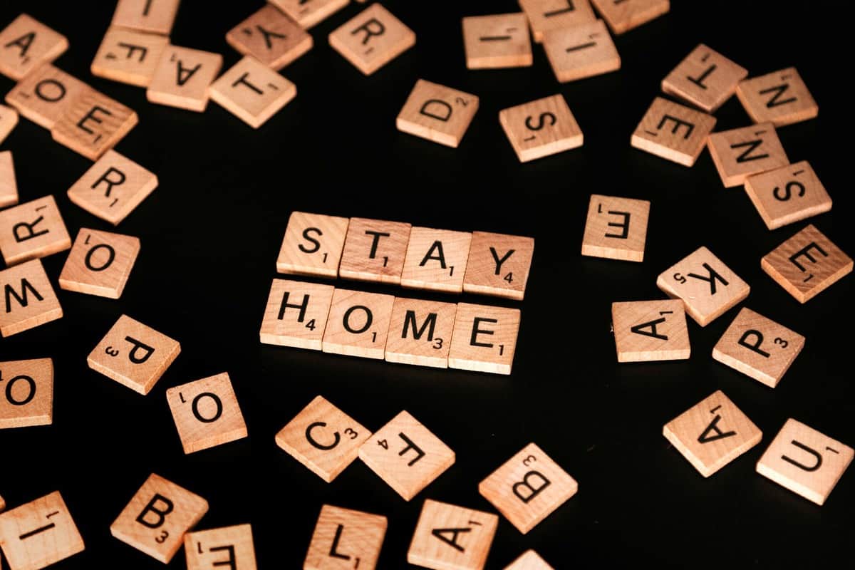 Several scrabble letters pushed together to say "stay home".