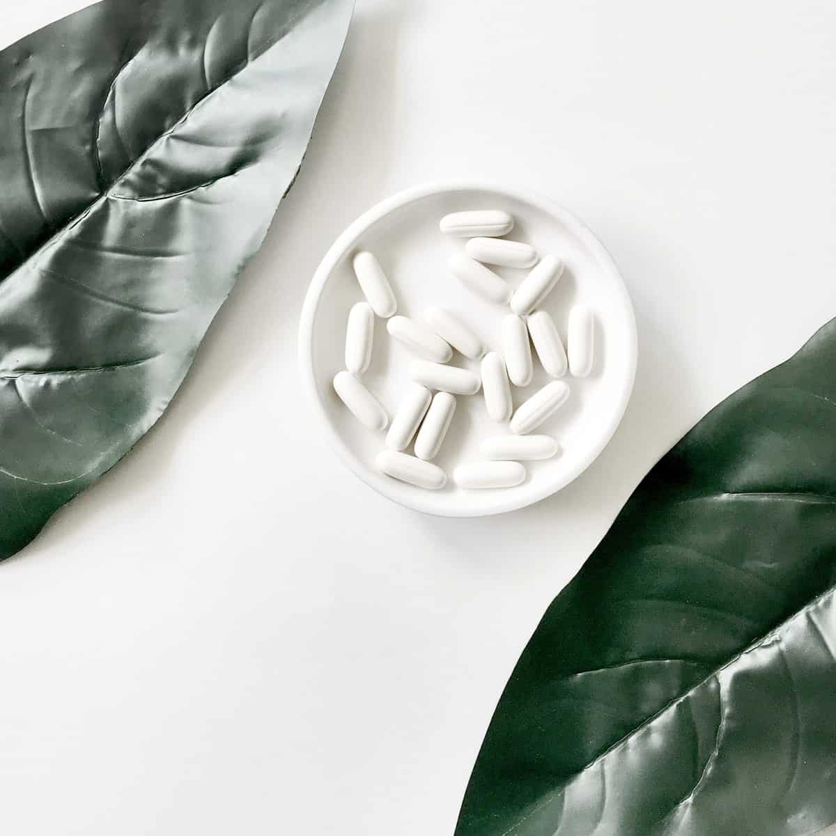 Several white supplements in a white dish.