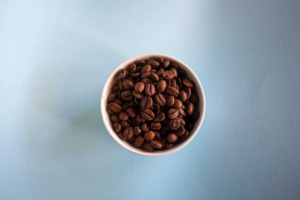 A birds eye view of a cup of coffee beans. 