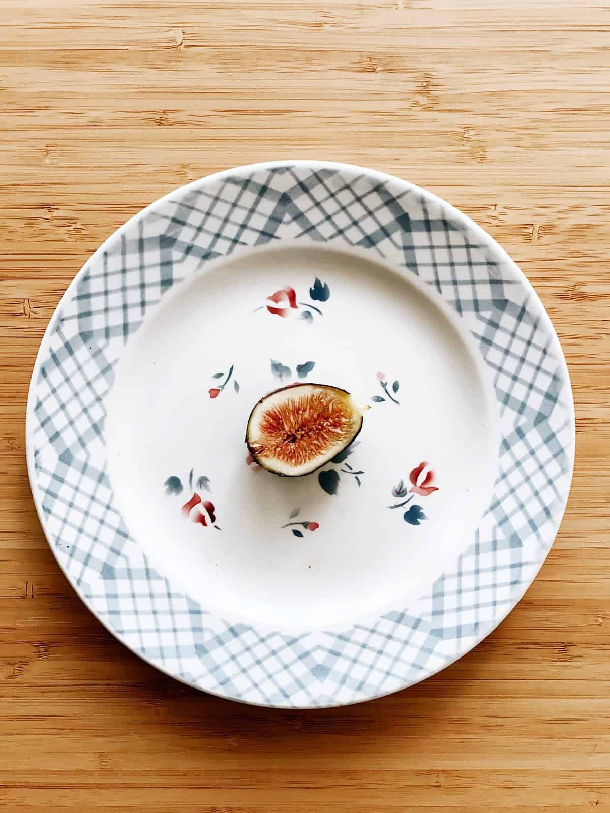 A single fig on a plate to demonstrate how restrictive intuitive fasting is. 