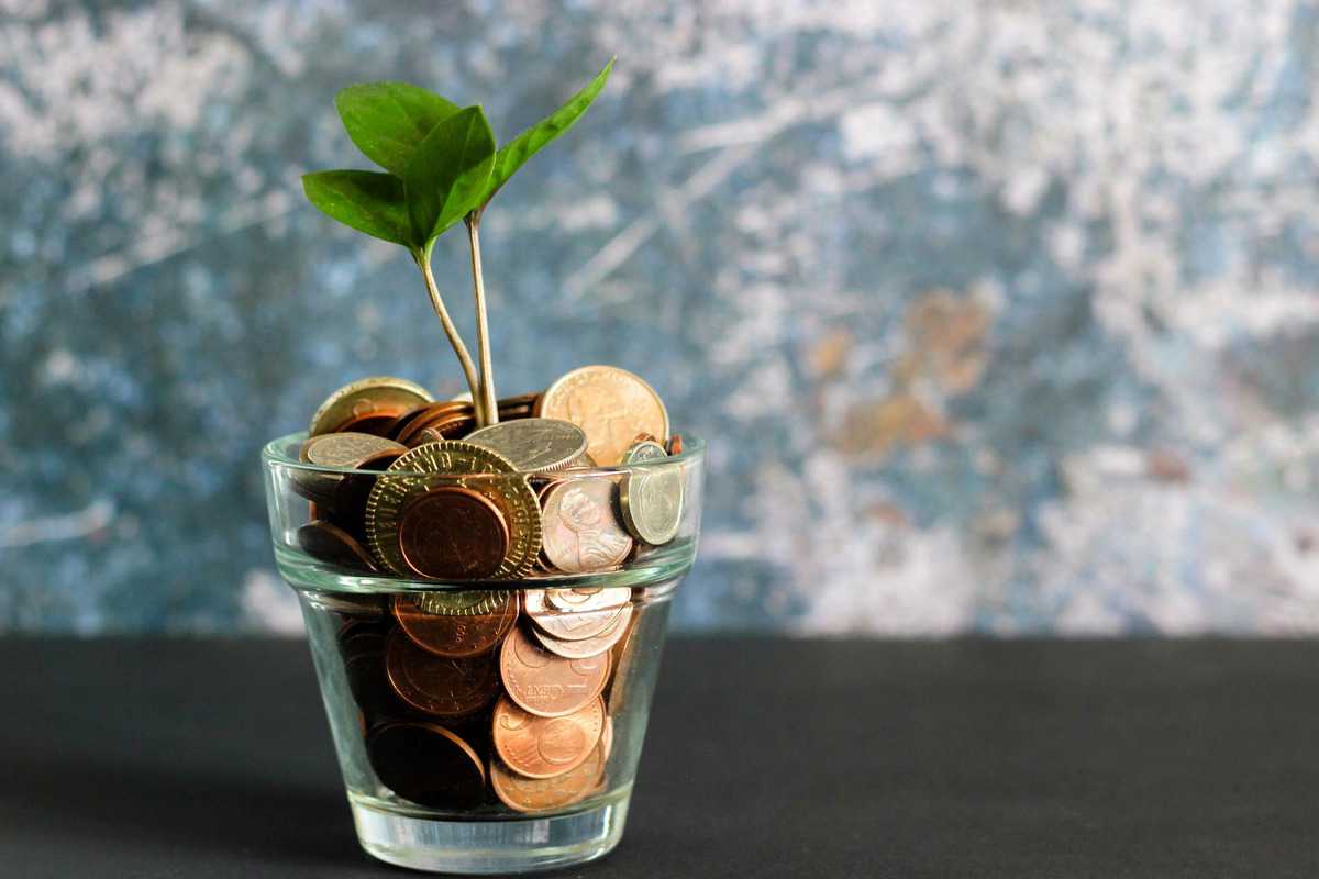 Several coins in a clear glass. 