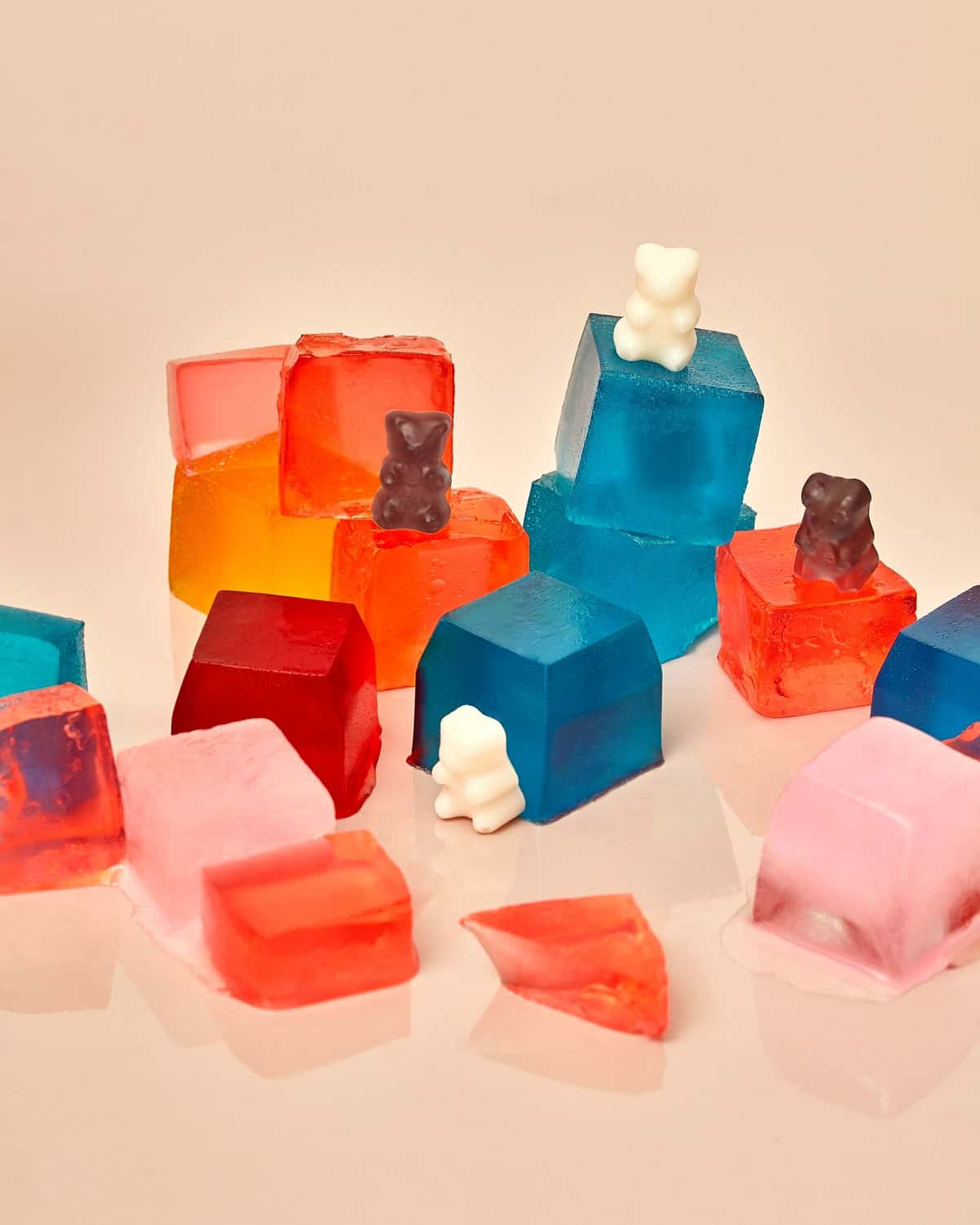 Several gummy bears sitting on jello. 