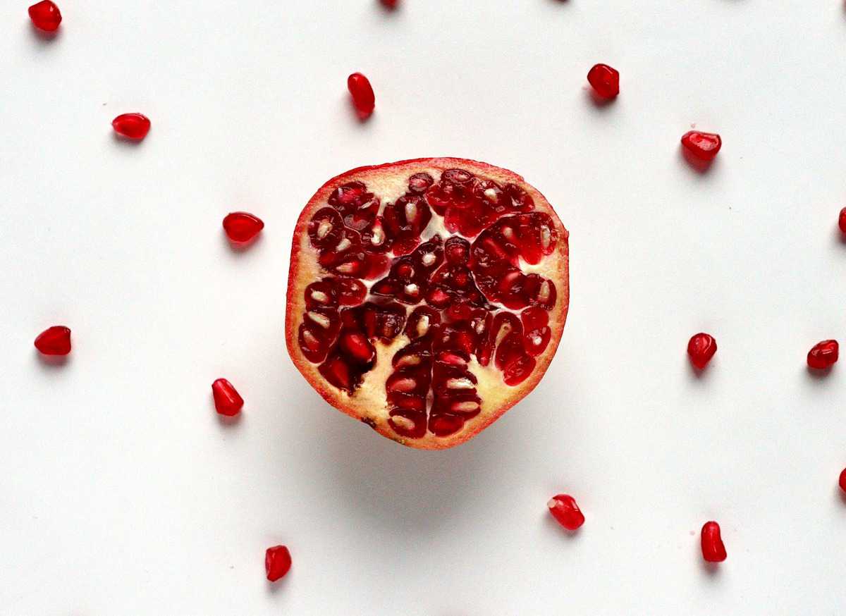Flat lay image of the inside of a pomegranate. 