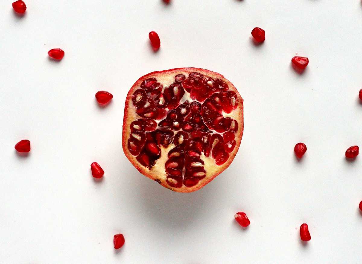 Flat lay image of the inside of a pomegranate.