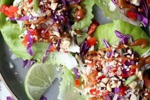 Pinterest graphic of a plate of three chicken lettuce wraps with the text overlay "no-cook chicken lettuce wraps."