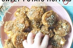 Pinterest graphic of a hand reaching of a sweet potato muffin with the overlay text "baby lean weaning sweet potato muffins."