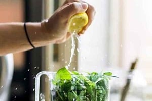 Pinterest graphic of a lemon being squeezed into a pitcher of green juice with text overlay "goop detox diets to avoid."