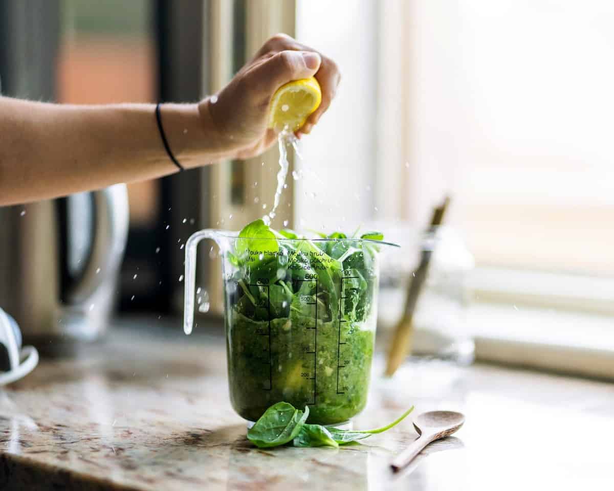 Person preparing a detox smoothie from GOOP. 