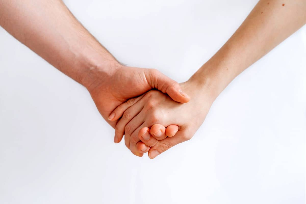 Two people holding hands.