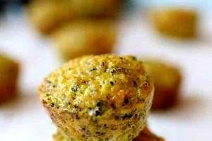 Pinterest graphic of a stack of egg minis with the overlay text "broccoli and cheese egg muffins."