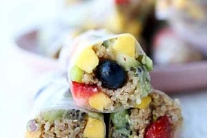 Pinterest graphic of three rolls with the overlay text "super easy fruit spring rolls."