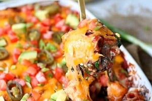 Pinterest graphic of a Mexican pasta casserole with a spoonful being scooped up.