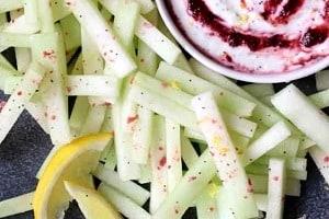 Pinterest graphic of melon sticks with a dip with the text overlay "easy vegan snack summer melon sticks."