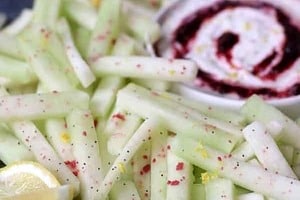 Pinterest graphic of a plate of melon sticks with a dip on the side.