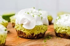 A mini vegan key lime pie on a serving board.