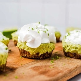 A mini vegan key lime pie on a serving board.