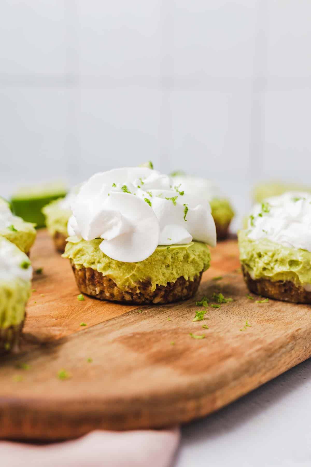 A mini vegan key lime pie on a serving board.