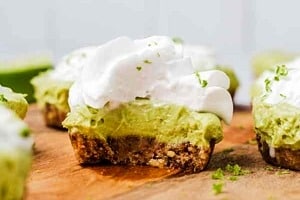 Pinterest graphic of a key lime pie with a bite taken out with the text overlay "vegan key lime pie."