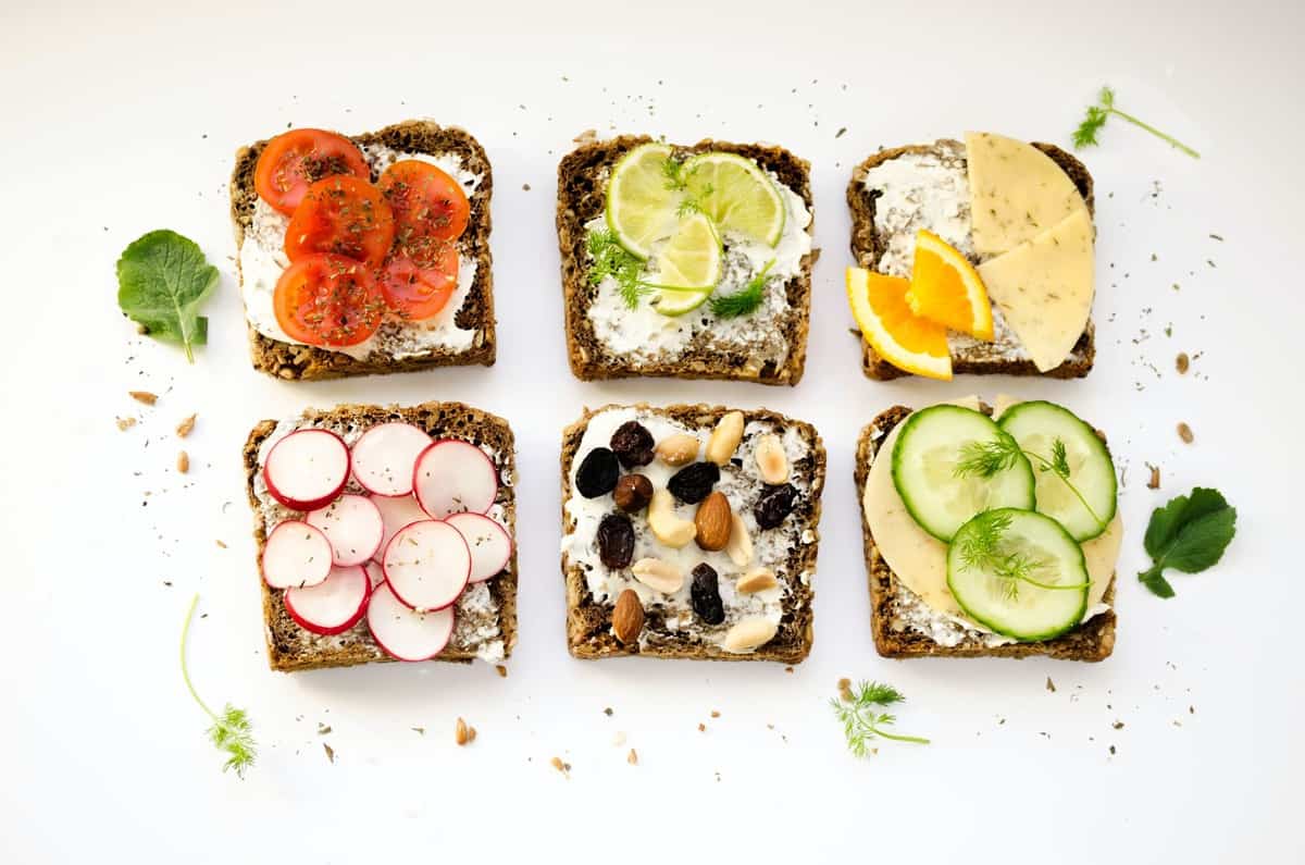 Six pieces of toast with a variety of toppings.