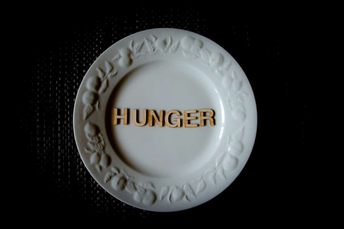 The letters "hunger" written on a white plate.