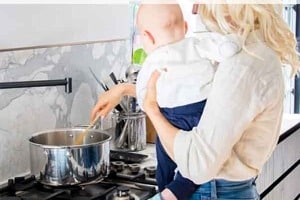 Pinterest graphic of a woman holding a baby while stirring a pot with the text overlay "mental health pregnancy, drugs, & anxiety."