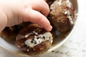 Pinterest graphic of a baby's hand reaching for toddler meatballs.