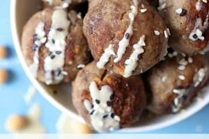 Pinterest graphic of a bowl of toddler meatballs with tahini drizzle and text "Toddler Meatballs With Hummus."