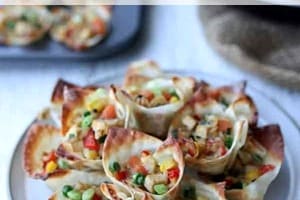 Pinterest graphic of a plate of tofu fried rice cups stacked on top of each other.