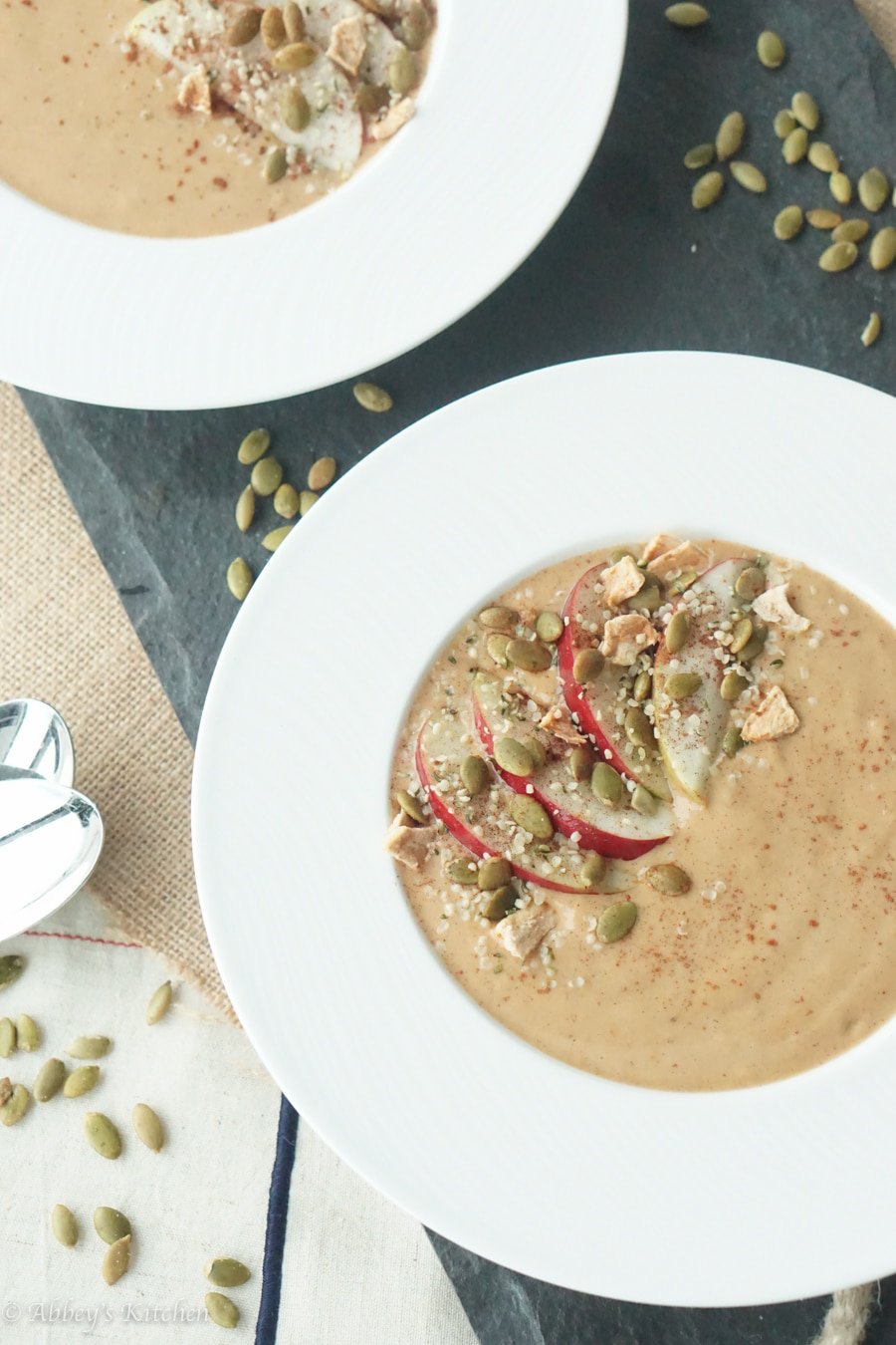 Birds eye view image of pumpkin pie protein smoothie bowls wth toppings.